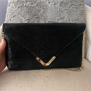 BEBE black clutch with gold hardware